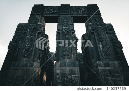 Ancient Monumental Stone Gateway with Historical Relief Sculptures and Cultural Heritage Figures 140257389