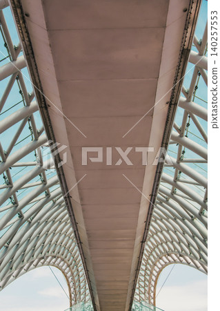 Modern Pedestrian Bridge with Futuristic Steel Structure and Glass Elements 140257553