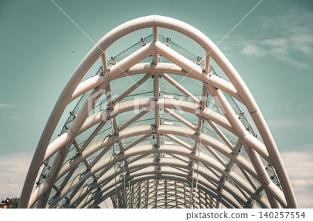 Modern Pedestrian Bridge with Futuristic Steel Structure and Glass Elements 140257554