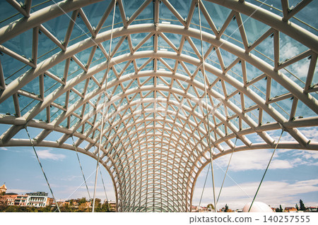 Modern Pedestrian Bridge with Futuristic Steel Structure and Glass Elements 140257555