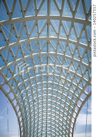 Modern Pedestrian Bridge with Futuristic Steel Structure and Glass Elements Modern Pedestrian Bridge with Futuristic Steel Structure and Glass Elements 140257557