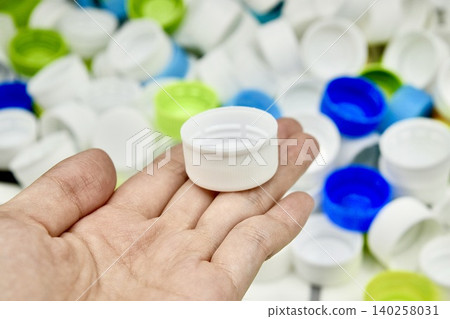 plastic bottle cap and hand plastic bottle cap and hand 140258031