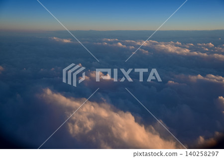 Looking through the airplane window with the sunset sky. Romantic sky, golden hours, colorful sunset sky with clouds. Stunning cloudscape and skyscape. Nature concept. For background use. 140258297
