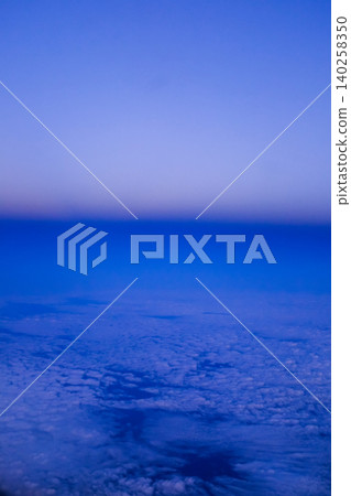 Looking through the airplane window with the sunset sky. Romantic sky, golden hours, colorful sunset sky with clouds. Stunning cloudscape and skyscape. Nature concept. For background use. 140258350