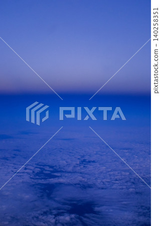 Looking through the airplane window with the sunset sky. Romantic sky, golden hours, colorful sunset sky with clouds. Stunning cloudscape and skyscape. Nature concept. For background use. Looking through the airplane window with the sunset sky. Romantic sky, golden hours, colorful sunset sky with clouds. Stunning cloudscape and skyscape. Nature concept. For background use. 140258351