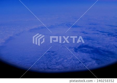 Looking through the airplane window with the sunset sky. Romantic sky, golden hours, colorful sunset sky with clouds. Stunning cloudscape and skyscape. Nature concept. For background use. Looking through the airplane window with the sunset sky. Romantic sky, golden hours, colorful sunset sky with clouds. Stunning cloudscape and skyscape. Nature concept. For background use. 140258352