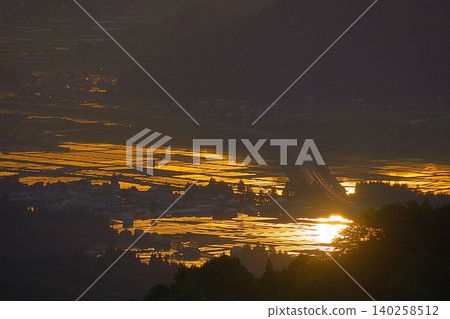 The sunrise reflected in the rice paddies at Uonuma Skyline. The sunrise reflected in the rice paddies at Uonuma Skyline. 140258512