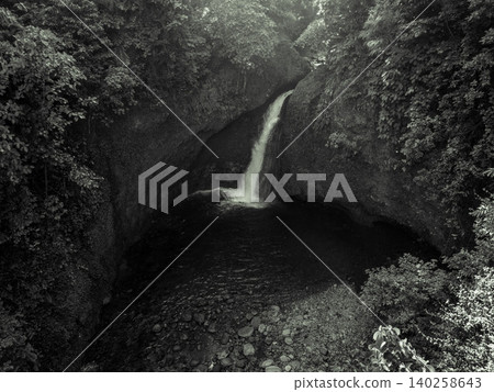 Aerial view of a hidden waterfall deep within the lush tropical rainforest of Mount Daun Aerial view of a hidden waterfall deep within the lush tropical rainforest of Mount Daun 140258643