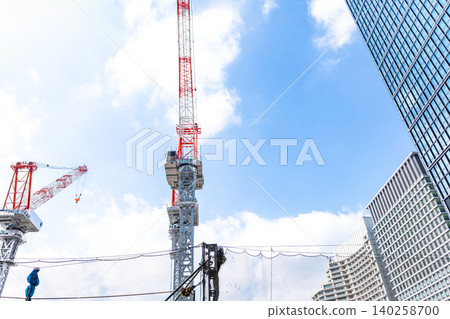 Large cranes and skyscrapers at a construction site Large cranes and skyscrapers at a construction site 140258700