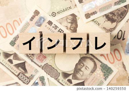 A block with the word "inflation" written on it and lots of 10,000 yen bills. A block with the word "inflation" written on it and lots of 10,000 yen bills. 140259350