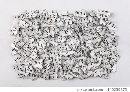 Scraps of paper with words and letters from magazines and newspapers. Newspaper paper strips background. 140259875