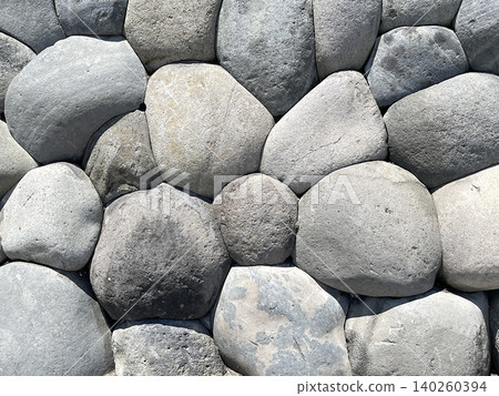 Texture background of a stone wall made of stacked natural stones Texture background of a stone wall made of stacked natural stones 140260394