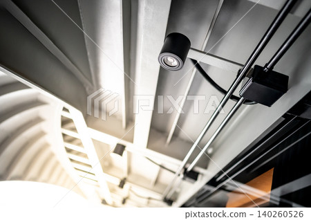 Modern black cylinder downlight lamp or cylindrical LED spotlight hanging on the ceiling Modern black cylinder downlight lamp or cylindrical LED spotlight hanging on the ceiling 140260526