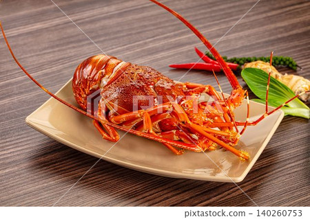 Red Spiny Lobster on Beige Plate with Chili Peppers and Ginger Red Spiny Lobster on Beige Plate with Chili Peppers and Ginger 140260753