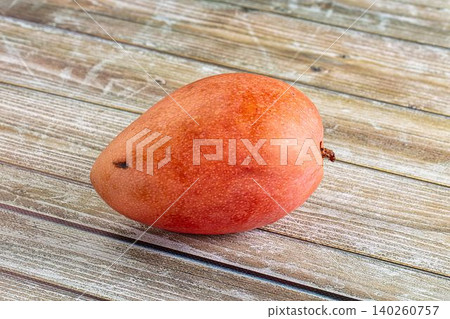 Ripe mango fruit on rustic wooden surface Ripe mango fruit on rustic wooden surface 140260757