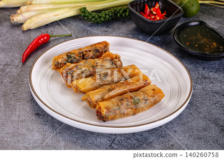 Fried spring rolls with fresh ingredients and dipping sauce on dark background 140260758