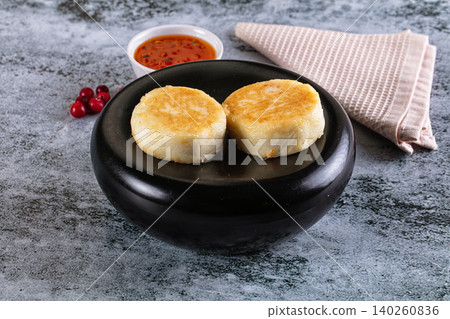 Golden Fried Cheese Pancakes on Black Plate with Red Berry Sauce and Fresh Cranberries Golden Fried Cheese Pancakes on Black Plate with Red Berry Sauce and Fresh Cranberries 140260836