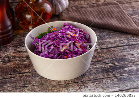 Red cabbage salad in white bowl on rustic wooden table Red cabbage salad in white bowl on rustic wooden table 140260852