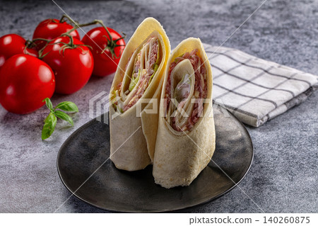Fresh Tortilla Wraps with Ham and Cheese on Dark Plate Fresh Tortilla Wraps with Ham and Cheese on Dark Plate 140260875