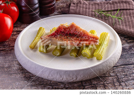 Grilled red mullet fillet on celery stalks with fresh tomatoes and rosemary Grilled red mullet fillet on celery stalks with fresh tomatoes and rosemary 140260886