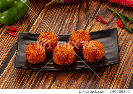 Crispy fried croquettes on black plate Crispy fried croquettes on black plate 140260893