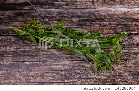 Fresh tarragon bundle lying on rustic wooden surface Fresh tarragon bundle lying on rustic wooden surface 140260994