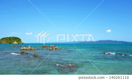Coastal scenery of Yagaji Fishing Port in Okinawa: Emerald green sea, rocky reefs, and blue sky. Coastal scenery of Yagaji Fishing Port in Okinawa: Emerald green sea, rocky reefs, and blue sky. 140261118