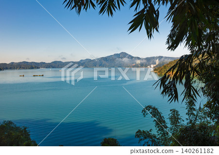 Bamboo leaves above Sun Moon Lake panorama Bamboo leaves above Sun Moon Lake panorama 140261182