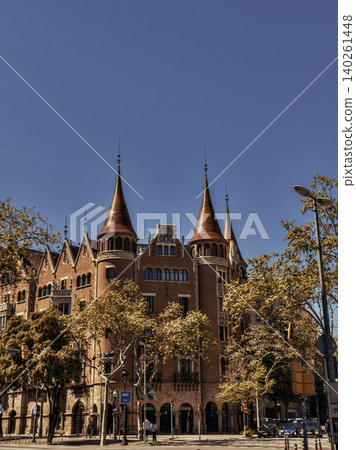 Historic castle-like brick building with ornate towers and trees Historic castle-like brick building with ornate towers and trees 140261448