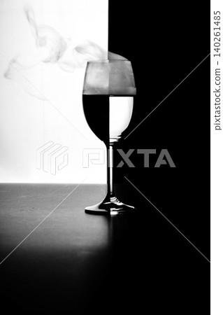 a glass of water and smoke on a black and white background a glass of water and smoke on a black and white background 140261485
