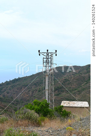 High voltage transmission towers and electrical substation at sunset High voltage transmission towers and electrical substation at sunset 140261524
