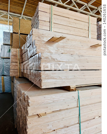 Stacks of wooden planks neatly arranged at indoor construction warehouse Stacks of wooden planks neatly arranged at indoor construction warehouse 140261658