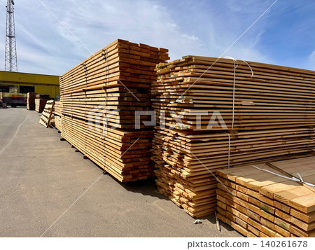 Stacks of wooden boards are neatly arranged at an outdoor construction warehouse Stacks of wooden boards are neatly arranged at an outdoor construction warehouse 140261678