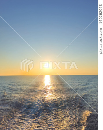 Image of sunset at sea horizon with waves from a ship Image of sunset at sea horizon with waves from a ship 140262068