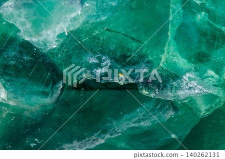 Macro mineral stone Fluorite crystal on a black background Macro mineral stone Fluorite crystal on a black background 140262131