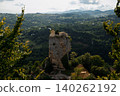 A solitary, enormous rock: the Katskhi Pillar. The monastery sits atop a cliff surrounded by trees. 140262192