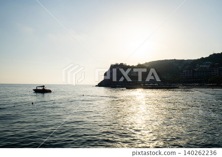 Waves crashing splashing sandy beach on seashore in Antalya Turkey during sunset. Sea vacation travel tourism scene concept. Tranquility and slowing down Waves crashing splashing sandy beach on seashore in Antalya Turkey during sunset. Sea vacation travel tourism scene concept. Tranquility and slowing down 140262236