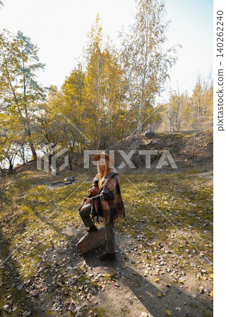 Portrait of smiling caucasian artist plays wooden acoustic guitar in autumnal park. Young songwriter plays string musical instrument hobby outside in nature fall time. Audio music healing Portrait of smiling caucasian artist plays wooden acoustic guitar in autumnal park. Young songwriter plays string musical instrument hobby outside in nature fall time. Audio music healing 140262240