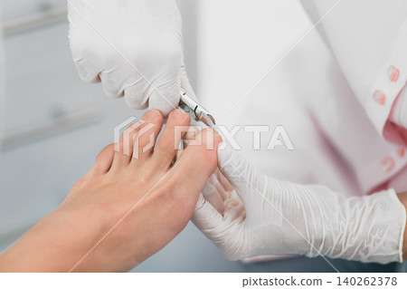 Beautician trimming clients Toenail. Hygienic Manicure Process 140262378