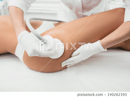 woman having cavitation procedure, cellulite treatment, on her buttocks and legs woman having cavitation procedure, cellulite treatment, on her buttocks and legs 140262393