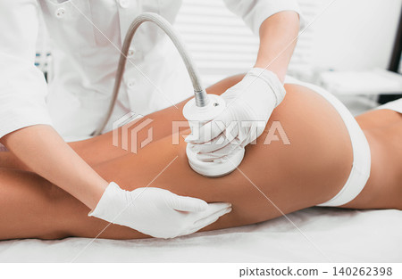 woman having cavitation procedure, cellulite treatment, on her buttocks and legs woman having cavitation procedure, cellulite treatment, on her buttocks and legs 140262398