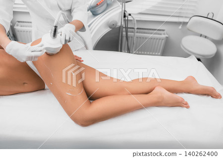 woman having cavitation procedure on legs and buttocks , cellulite treatment at beauty clinic woman having cavitation procedure on legs and buttocks , cellulite treatment at beauty clinic 140262400