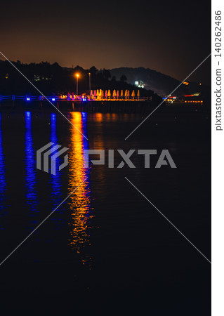 Moonlight Over Sea Waves Full Moon Glow ocean waves on sandy beach at night wooden pier. The moon illuminates water surface. Concept of beach vacation slowing down on seacoast 140262486