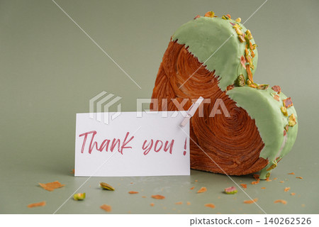 THANK YOU text thanksgiving day Delightful and vibrant heartshaped pastry croissant treat, beautifully topped with colorful frosting nut galore. Mock up template copy space. Food experimentation viral 140262526