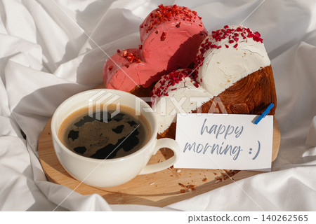 HAPPY MORNING wishes saying caption on greeting card Coffee breakfast in rumpled bedding bed with heartshaped pastry croissant treat. Food experimentation viral dessert baking trend HAPPY MORNING wishes saying caption on greeting card Coffee breakfast in rumpled bedding bed with heartshaped pastry croissant treat. Food experimentation viral dessert baking trend 140262565