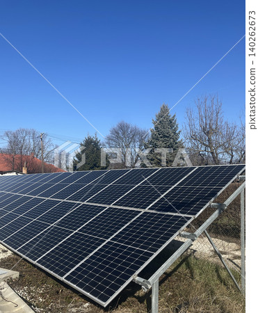 Solar Panel Installation with Evergreen Tree - Renewable Energy Photography Solar Panel Installation with Evergreen Tree - Renewable Energy Photography 140262673