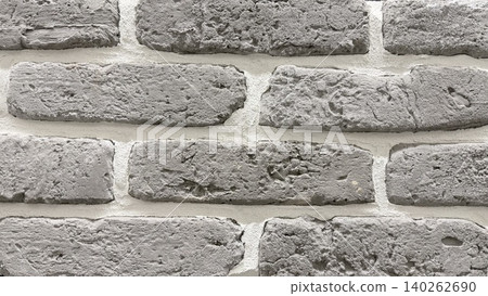 Gray brick wall texture in close-up with rough surface and white mortar joints. Gray brick wall texture in close-up with rough surface and white mortar joints. 140262690
