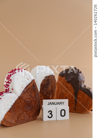Croissant day 30 January wooden calendar cubes wishes greeting holiday card Heartshaped pastry croissant treat topped with colorful frosting galore. Food experimentation viral dessert baking trend 140262726