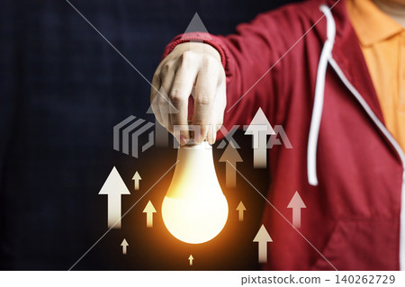 Rising Energy Cost Concept with Hand Holding Glowing Light Bulb and Upward Arrows. Growth Up. Innovation, Strategy and Solution Concept. High quality photo Rising Energy Cost Concept with Hand Holding Glowing Light Bulb and Upward Arrows. Growth Up. Innovation, Strategy and Solution Concept. High quality photo 140262729