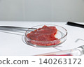 Cultured meat tissue in petri dish held by laboratory tweezers. Artificial beef sample from in vitro cultivation. Biotechnology for sustainable protein production and food security. photography 140263172